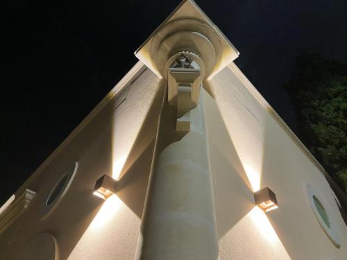 a white tower with lights on top of a building at Comfortable House with Fenced Garden - Surano - Fireplace in Surano
