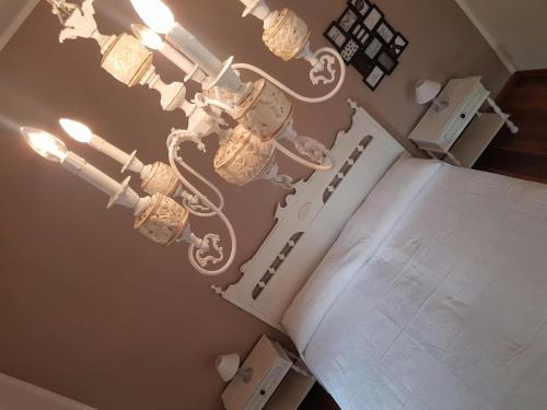 a chandelier hanging from the ceiling in a room at Dimora Damare in Caronia Marina