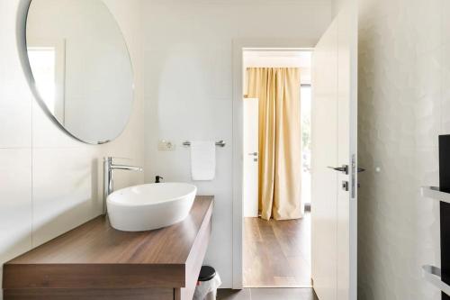 a bathroom with a white tub and a mirror at Villa Noel in Međugorje