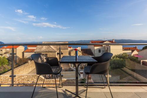 a table and chairs on a balcony with a view at Bol Summer Residence in Bol
