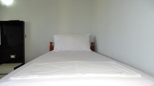 a bed in a room with a white mattress at Hotel Ardiani in Ksamil