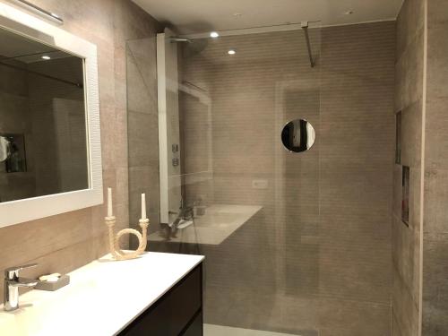 a bathroom with a shower and a sink and a mirror at Adosado para familias al lado de la playa, con piscina in Castellón de la Plana