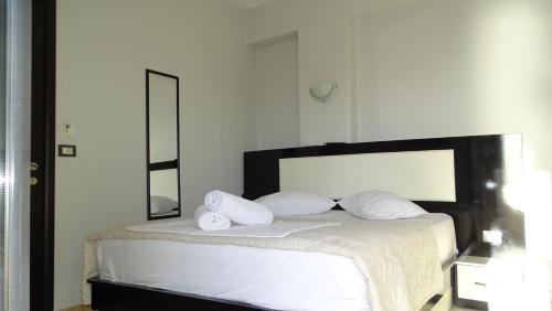 a bedroom with a bed with two white pillows at Hotel Ardiani in Ksamil