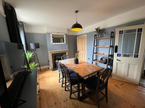a dining room with a wooden table and chairs at Charming 3 bedroom property in Bury St Edmunds in Bury Saint Edmunds