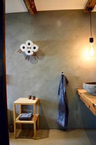 a bathroom with a toilet paper dispenser on the wall at The Sybilla Apartment - cosy and modern basement apartment in Klaksvík