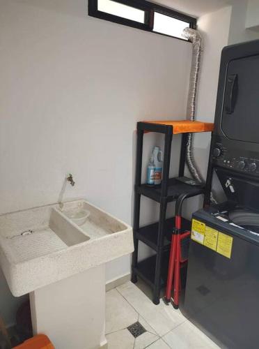 a kitchen with a sink and a fire hydrant at Altamar. Lugar perfecto para ser diamante in Acapulco