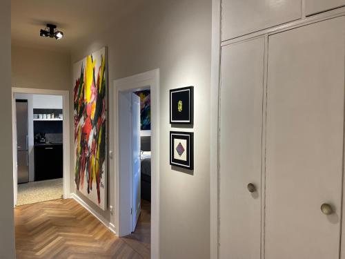a hallway with paintings on the walls of a room at Apartment Factory in Hamburg