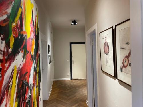 a hallway with paintings on the walls of a room at Apartment Factory in Hamburg