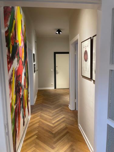 a hallway with paintings on the walls of a room at Apartment Factory in Hamburg