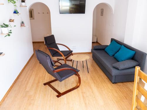 a living room with a couch and a chair at D&N Apartment in Ljubljana