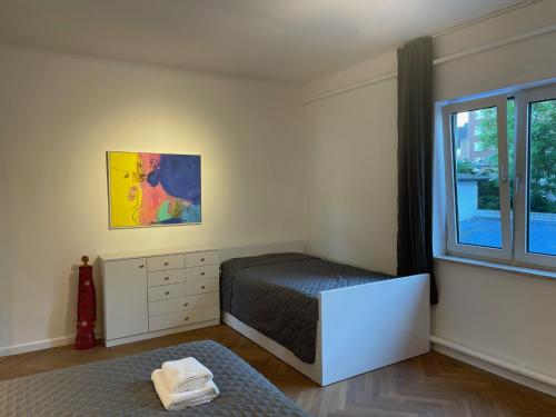 a small bedroom with a bed and a window at Apartment Factory in Hamburg