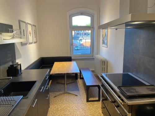 a small kitchen with a wooden table and a table sidx sidx sidx at Apartment Factory in Hamburg