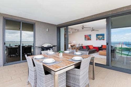 a dining room with a table and chairs at Darwin Waterfront Luxury Suites in Darwin