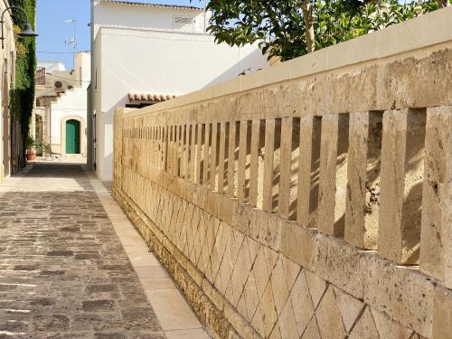a fence on the side of a street at Comfortable House with Fenced Garden - Surano - Fireplace in Surano