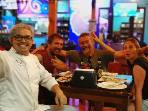 a group of people sitting at a table in a restaurant at Hotel Aldea Pura Vida in Puntarenas