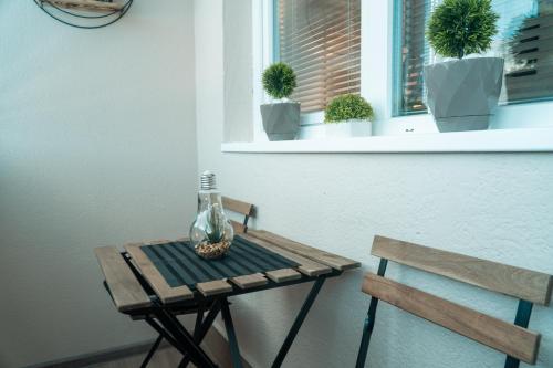 a wooden table with a vase on it next to a bench at NOA Luxury Apartment in Bitola