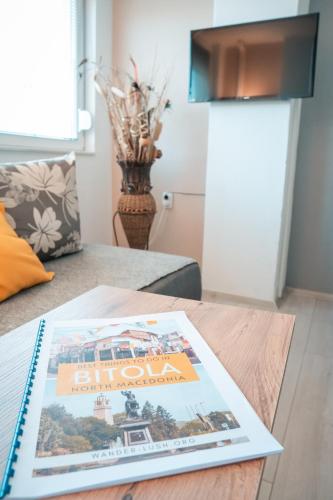 a magazine sitting on a coffee table in a living room at NOA Luxury Apartment in Bitola