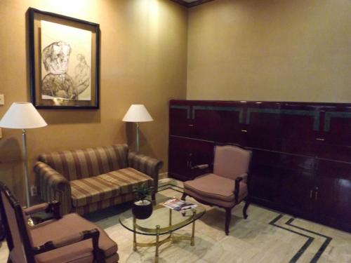 a living room with a couch and two chairs at Pedregal Palace in Mexico City