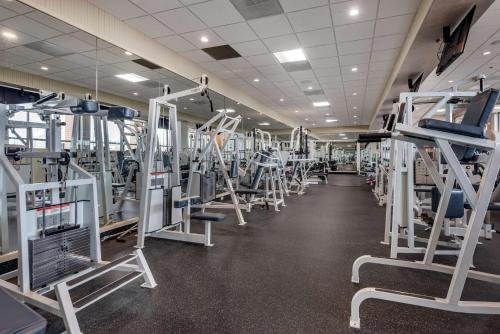 a gym with rows of treadmills and machines at Best Western Plus Oswego Hotel and Conference Center in Oswego