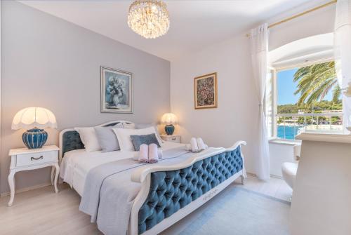 a bedroom with a large bed and a window at Apartment Rosana - ZF Hvar in Hvar