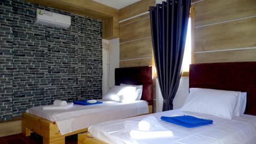 A bed or beds in a room at Limni Resort