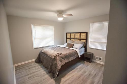 a bedroom with a bed and two windows at Decatur 2 BR Bliss Modern Comfort in Decatur