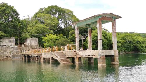 a wooden bridge in the middle of the water at Hotel Aldea Pura Vida in Puntarenas