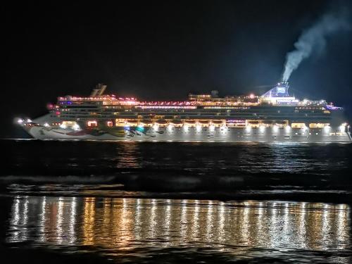 a cruise ship in the water at night at Hotel Aldea Pura Vida in Puntarenas