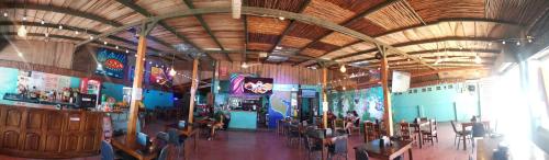 a dining room with tables and chairs in a restaurant at Hotel Aldea Pura Vida in Puntarenas