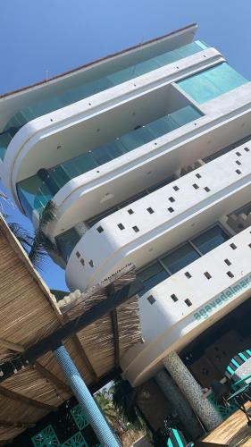 a building with two lounges on top of it at Condominio Agave del Mar in Coyuca