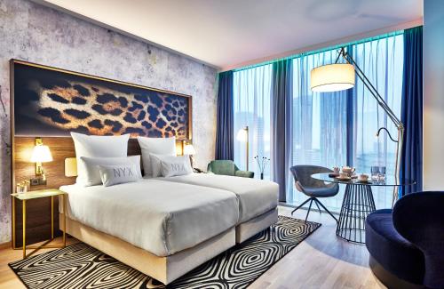 una camera d'albergo con un letto e una grande finestra di NYX Hotel Warsaw by Leonardo Hotels a Varsavia
