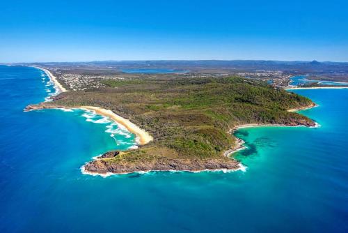 an aerial view of a small island in the ocean at 2 Ballin Wonderous White Waters in Sunshine Beach