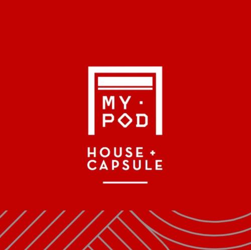 a red sign with the words my pod house capsule at My Pod House in Esquel
