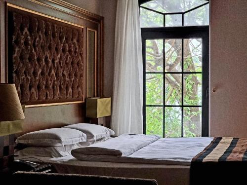 two beds in a room with a window at Sultan Inn Boutique Hotel in Baku