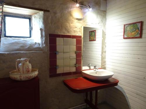 a bathroom with a sink and a window at Manor in Cotentin with Historic Charm in Saint-Lo-dʼOurville