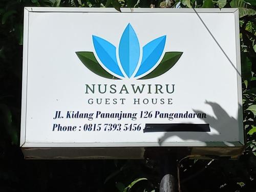 a sign for the nyssma guest house at Nusawiru Guest House in Pangandaran