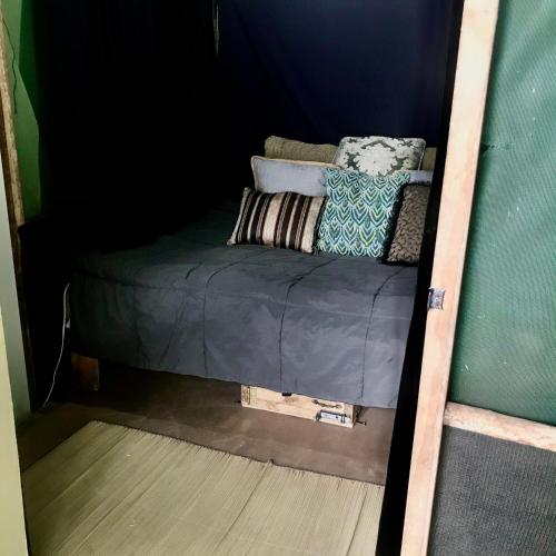 a bed in a room with pillows on it at Beachfront Paradise in Manuel Antonio