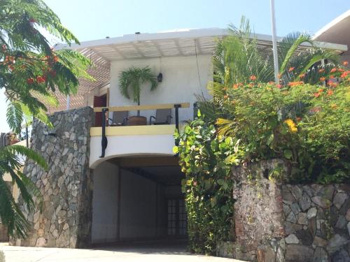 a house with a balcony with a plant on it at Fort Burt Hotel in Road Town