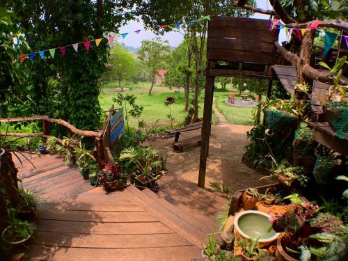 a garden with a bench and potted plants and a park at Nature Lodge in Sen Monorom