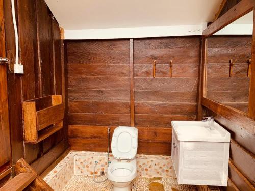 a bathroom with a toilet and a sink at Nature Lodge in Sen Monorom