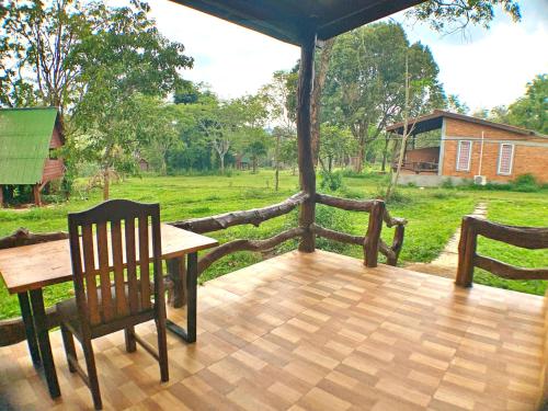 a wooden deck with a table and two chairs at Nature Lodge in Sen Monorom