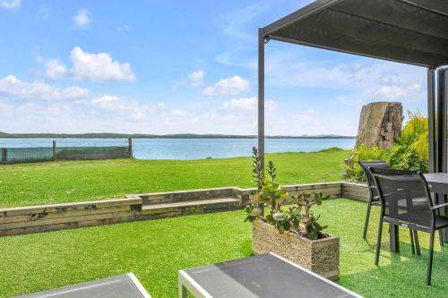 an outdoor patio with a view of the water at Dolphin Shores in Corlette