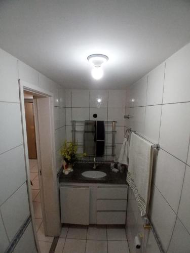 a bathroom with a sink and a mirror at ED House in Fortaleza