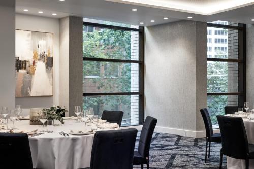 a conference room with tables and chairs and windows at Crowne Plaza Sydney Darling Harbour by IHG in Sydney