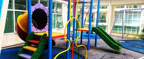 a playground with a slide in a building at My Dallyne's Homestay at Mutiara Ville Cyberjaya in Cyberjaya