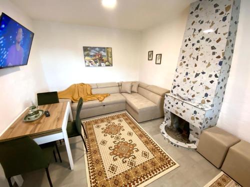a living room with a couch and a fireplace at Maison Bellevue - 2 bdrm villa in Borsh beach in Borsh