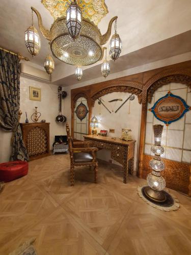 Habitación grande con mesa y lámpara de araña. en TAJ Royal APARTMENT, en Bucarest