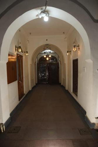 an empty hallway of a building with an archway at Hotel Swagatam in Bikaner
