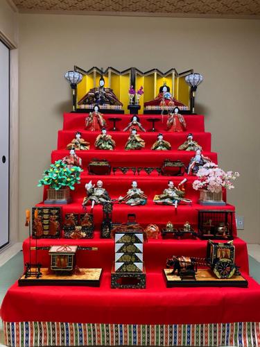 a red stair case with many items on it at vacation rental SARAKU 茶楽来 in Osaka