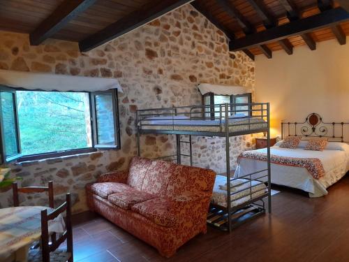 Una sala de estar con dos literas y un sofá. en Apartamentos Rurales Larrago, en Busturia